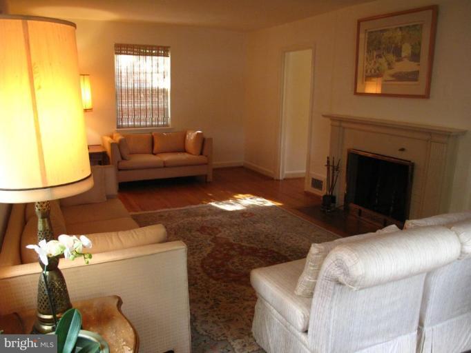 9508 Wire Avenue Silver Spring, MD 20901 - Photo 6 of 10 a living room with furniture a window and a fireplace