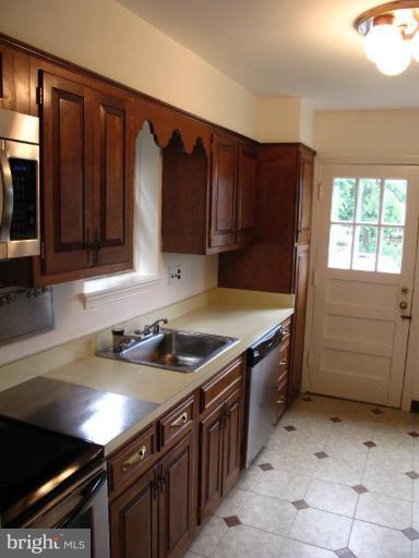 9508 Wire Avenue Silver Spring, MD 20901 - Photo 8 of 10 a kitchen that has a sink and a stove in it