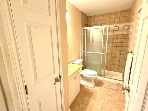 a bathroom with a toilet and a shower