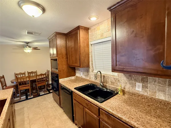 a kitchen that has a sink and a stove in it