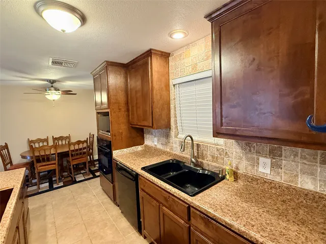 a kitchen that has a sink and a stove in it