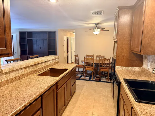 a kitchen with granite countertop a sink and a stove