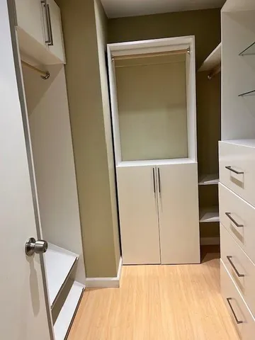 storage and utility room with wooden floor