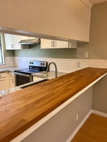 a kitchen with stainless steel appliances a sink and a stove