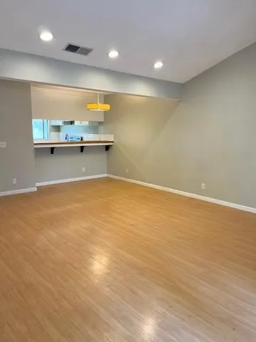 an empty room with wooden floor