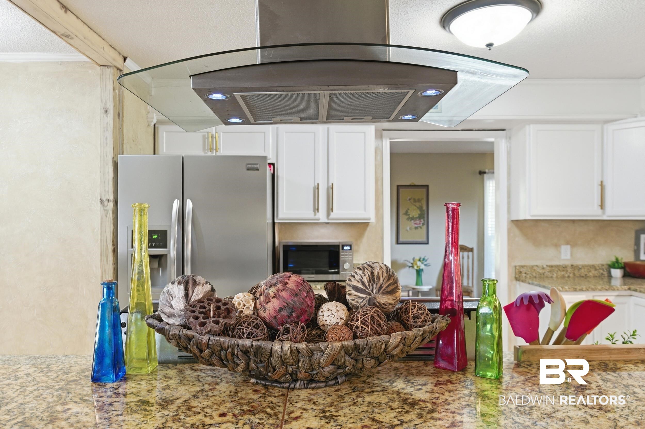 51620 Robert White Road Bay Minette, AL 36507 - Photo 23 of 81 Kitchen with granite countertops, white cabinetry, stainless steel refrigerator, and a contemporary glass and stainless steel range hood