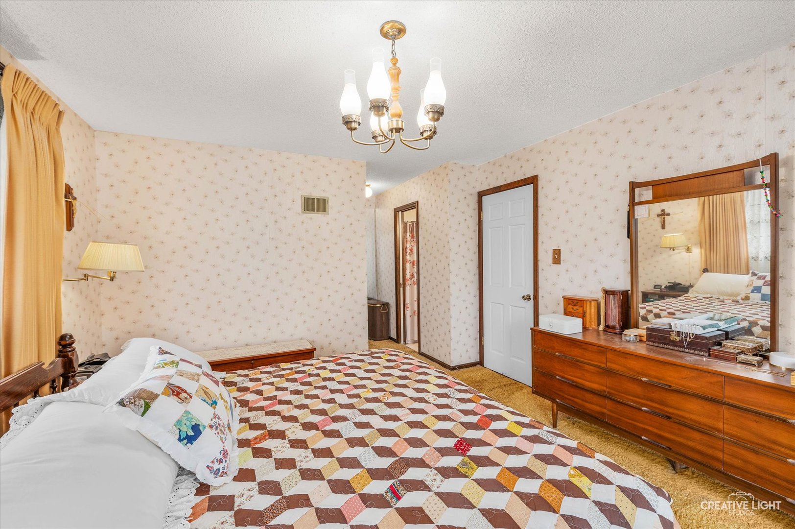 15304 South Indian Boundary Line Road Plainfield, IL 60544 - Photo 12 of 28 a bedroom with a bed and a chandelier