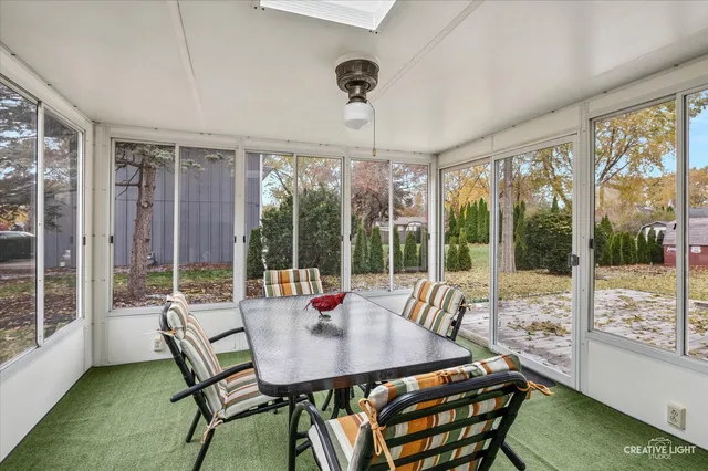 a view of a dining room with furniture large windows and wooden floor