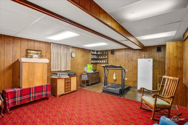 a living room with furniture pool table and chairs