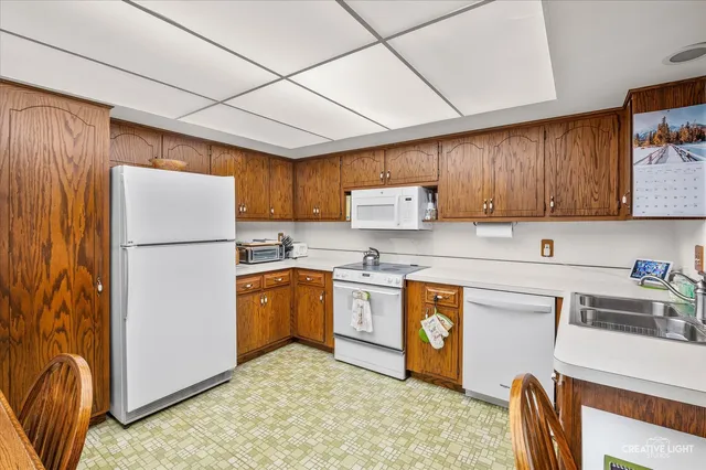 a kitchen with stainless steel appliances granite countertop a refrigerator stove microwave and sink