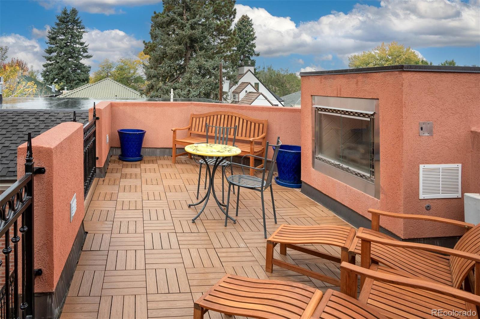 445 Madison Street Denver, CO 80206 - Photo 38 of 50 a view of a patio with table and chairs with wooden floor and fence