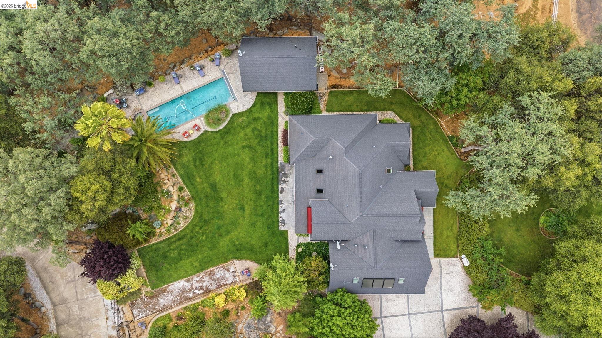 18450 Lambert Lake Road Sonora, CA 95370 - Photo 80 of 87 Expansive property featuring a multi-level roofline, lush green lawns, and mature perimeter trees