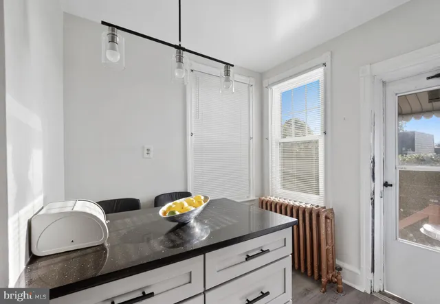 a bathroom with a granite countertop sink a mirror and shower