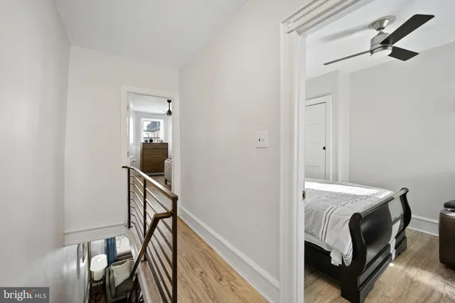 a bedroom with a bed and a ceiling fan