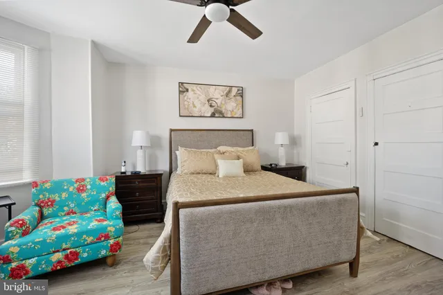 a bedroom with a bed and a dresser in it