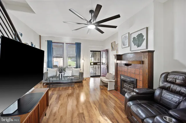 a living room with fireplace furniture and a flat screen tv