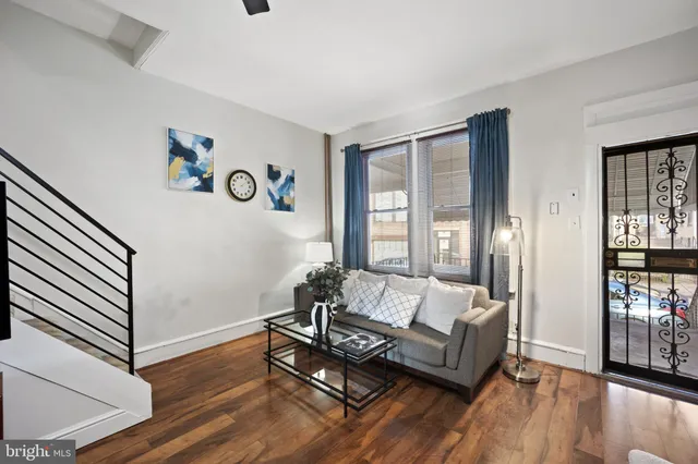 a living room with furniture and wooden floor