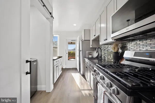a kitchen with a stove and a refrigerator