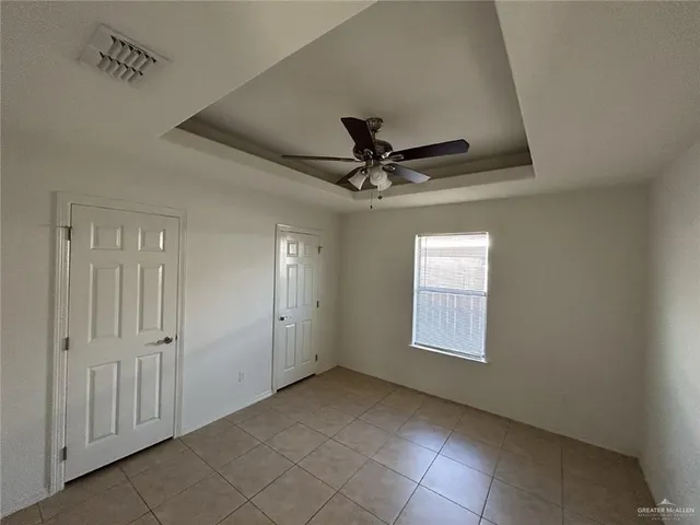 a view of a livingroom with a ceiling fan and window