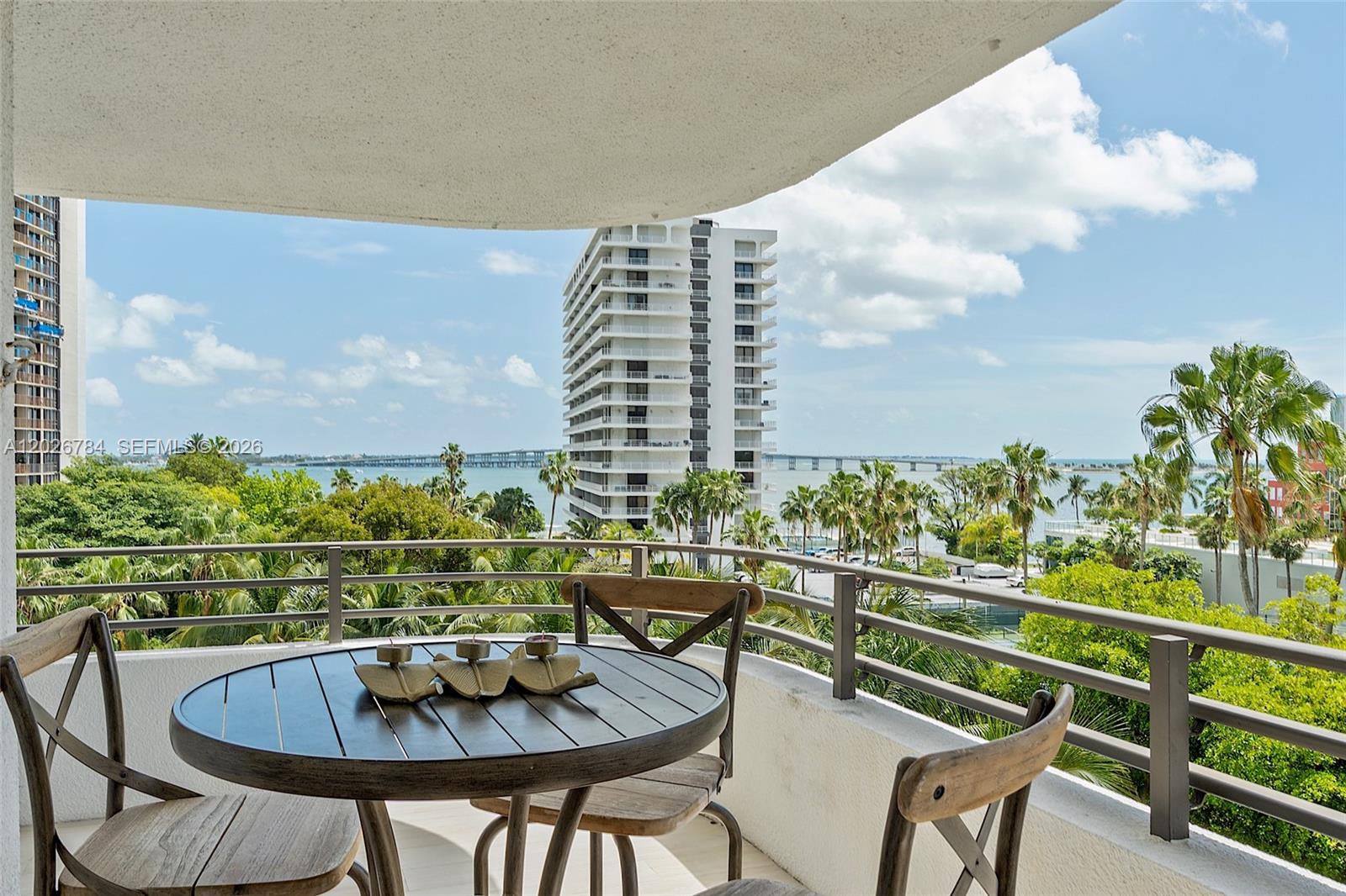 151 Southeast 15th Road, Unit 601 Miami, FL 33129 - Photo 9 of 36 a roof deck with table and chairs and potted plants