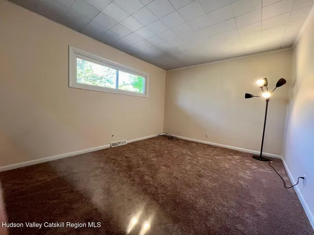 a view of an empty room and a window