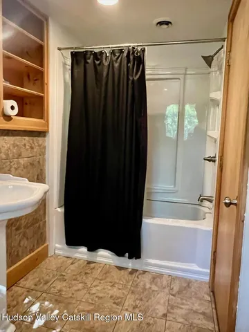 a bathroom with a shower and a tub