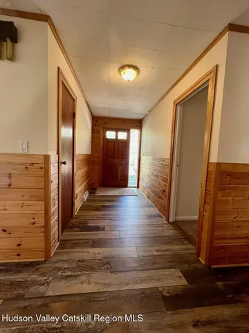 a view of hallway with stairs and wooden floor