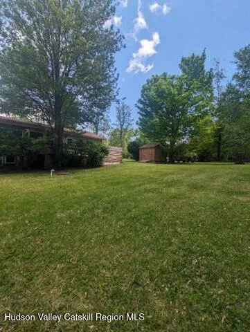 a view of a field of grass and trees