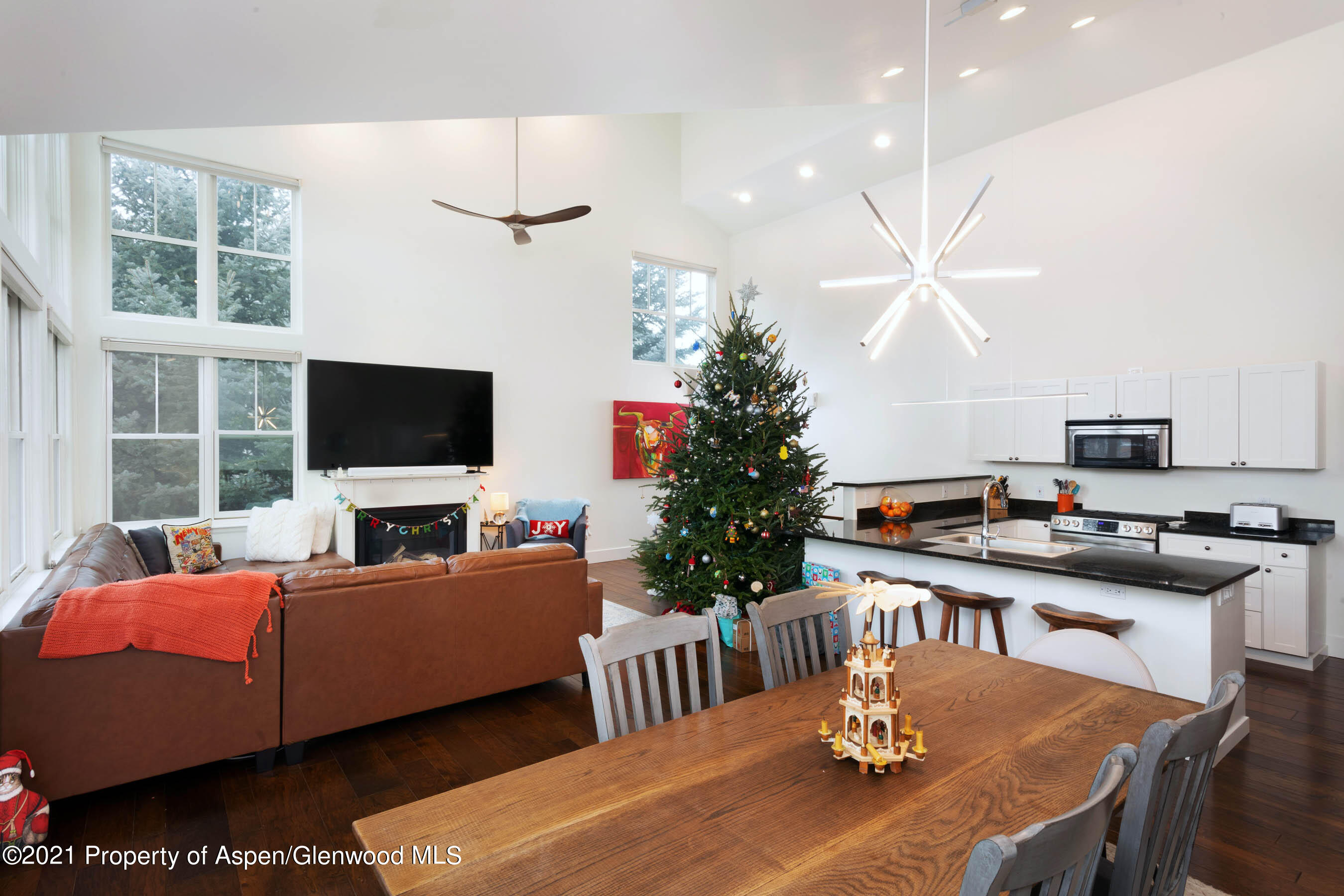 614 Evans Court Basalt, CO 81621 - Photo 11 of 34 a living room with furniture a flat screen tv and a chandelier