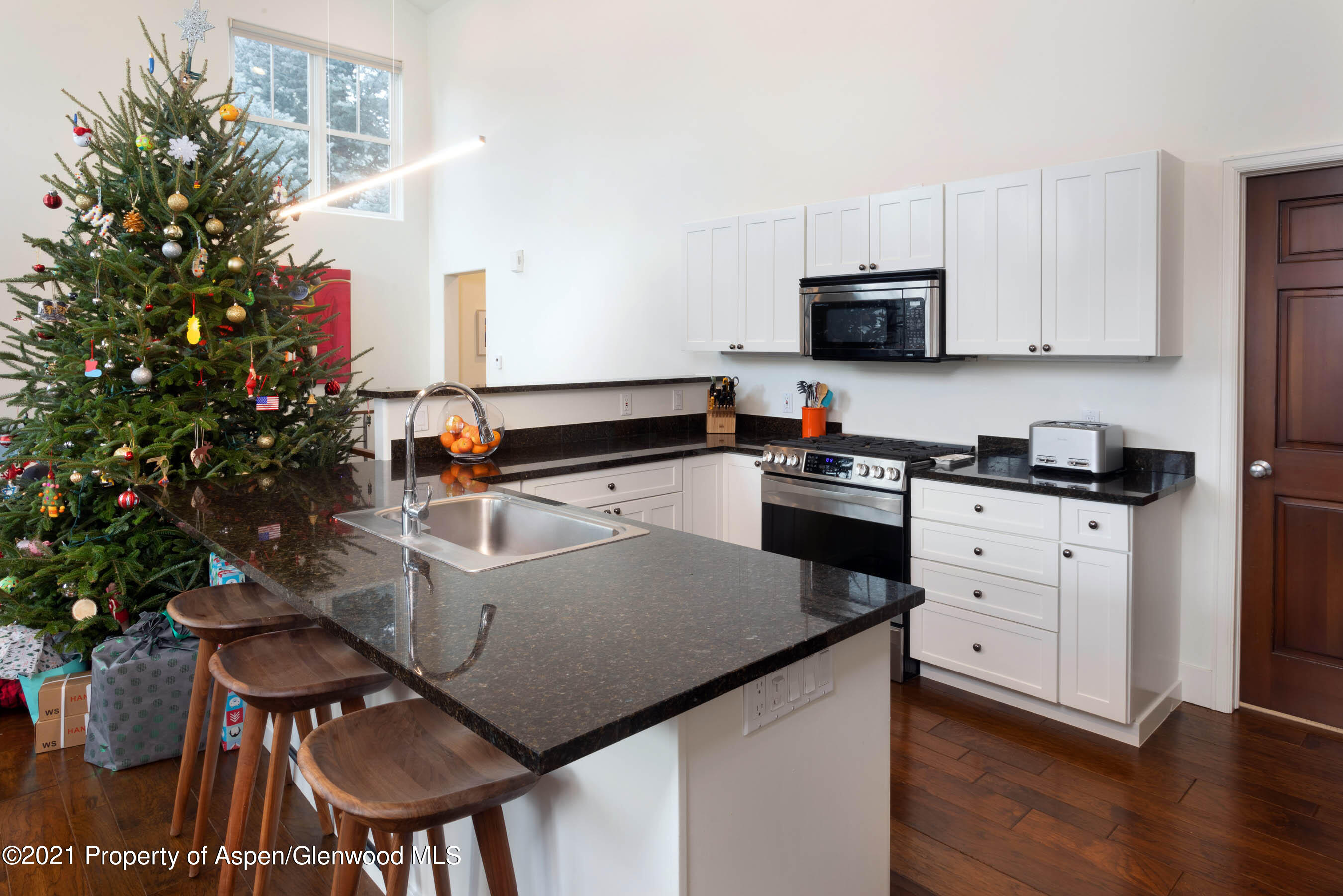 614 Evans Court Basalt, CO 81621 - Photo 15 of 34 a kitchen with a table chairs stove and cabinets
