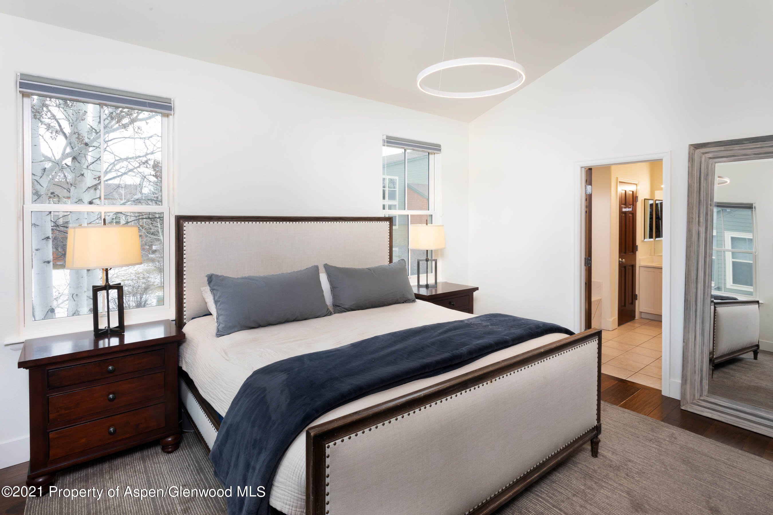 614 Evans Court Basalt, CO 81621 - Photo 19 of 34 a bedroom with a bed and a lamp on dresser
