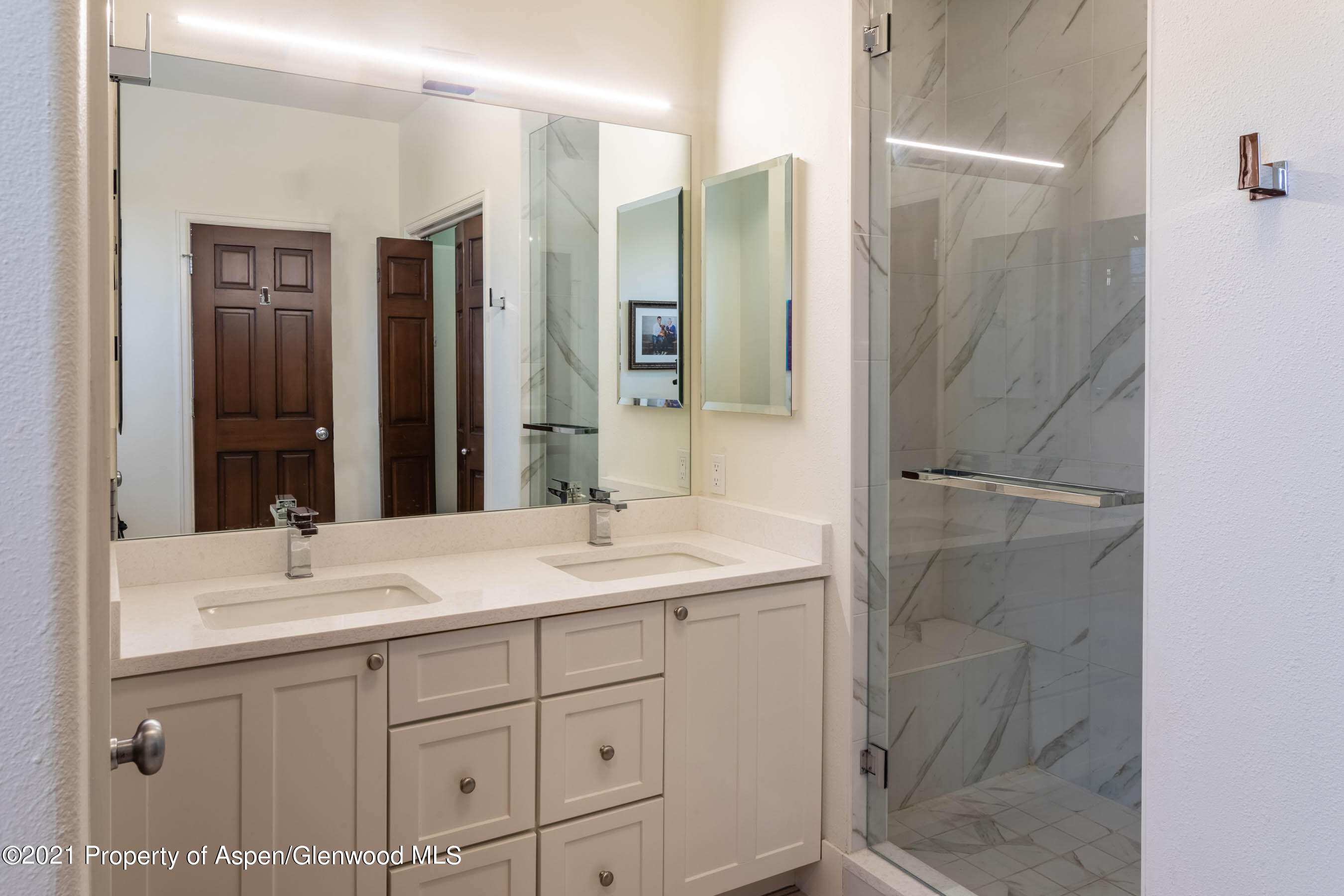 614 Evans Court Basalt, CO 81621 - Photo 23 of 34 a bathroom with a shower sink and mirror