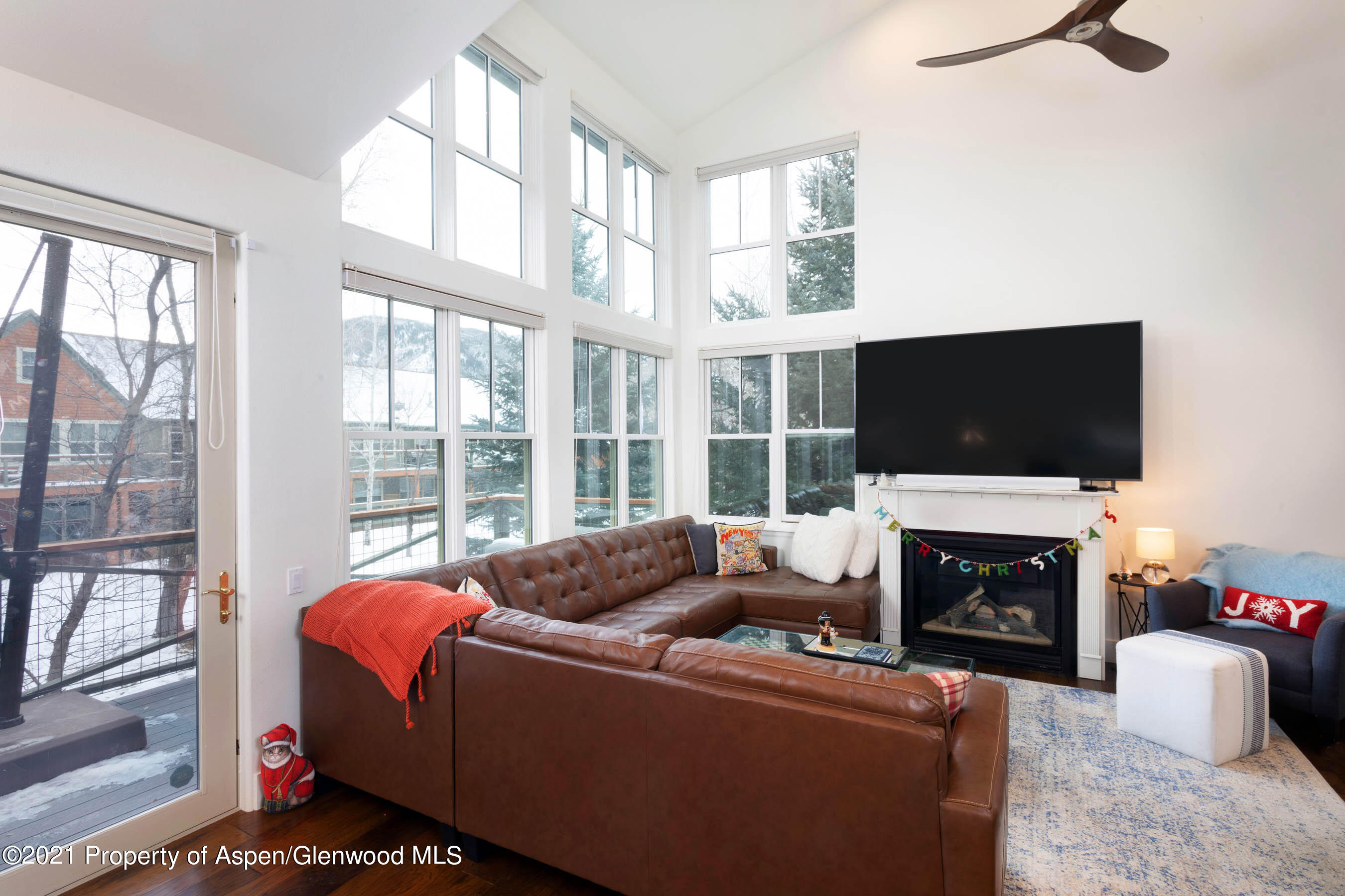 614 Evans Court Basalt, CO 81621 - Photo 10 of 34 a living room with furniture a fireplace and a flat screen tv