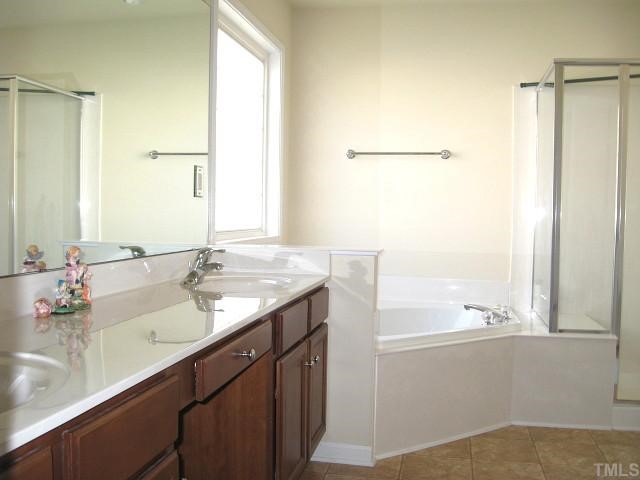 6607 Herndon Road Durham, NC 27713 - Photo 10 of 12 Gorgeous master bath with dual vanity areas, corner whirlpool, large shower, & water closet