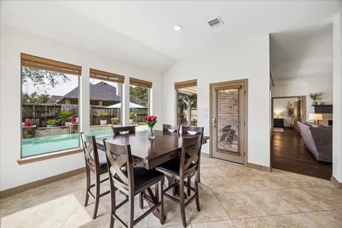 a view of a dining room and livingroom with furniture window and wooden floor