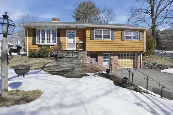 a view of a house with backyard and sitting area