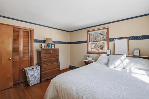 a bedroom with furniture and a window