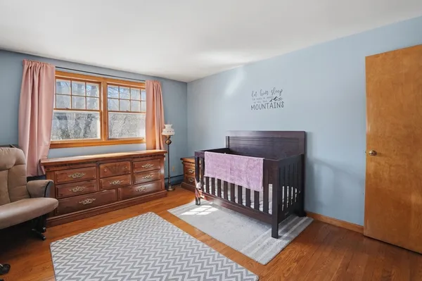 a bedroom with furniture and a window
