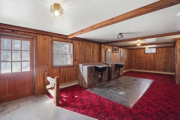 a living room with furniture a rug and a window
