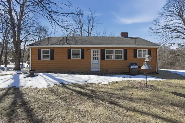 a front view of a house with a yard covered in snow