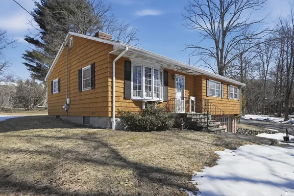 a front view of a house with a yard