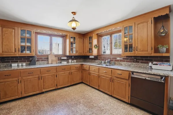 a large kitchen with kitchen island granite countertop a large window