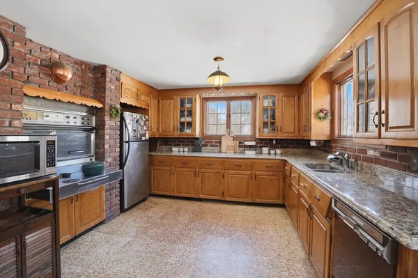 a kitchen with stainless steel appliances granite countertop a sink stove and refrigerator