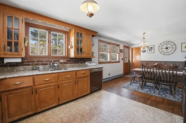 a spacious bathroom with a granite countertop sink and a large mirror