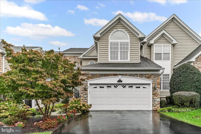 a view of a house with a yard and potted plants