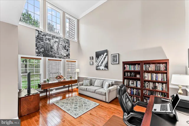 a living room with furniture a rug and a book shelf