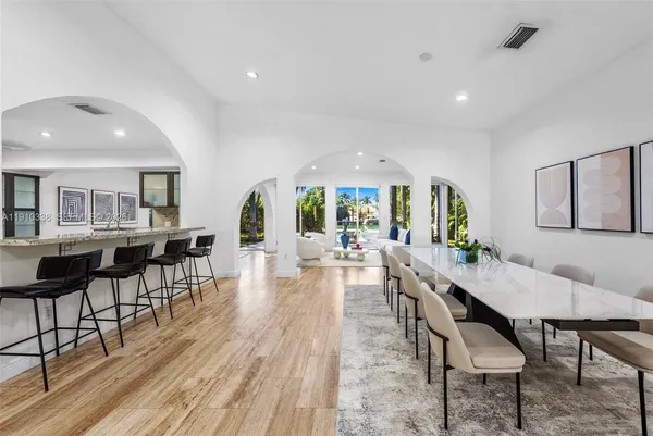 a dining room with furniture and wooden floor