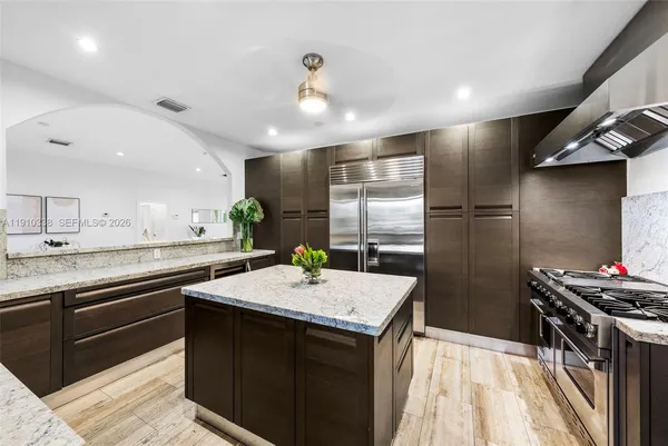a kitchen with a sink appliances and cabinets