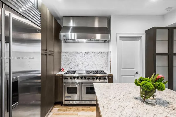 a kitchen with a stove and a refrigerator