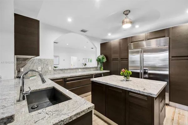 a kitchen with a sink appliances and cabinets